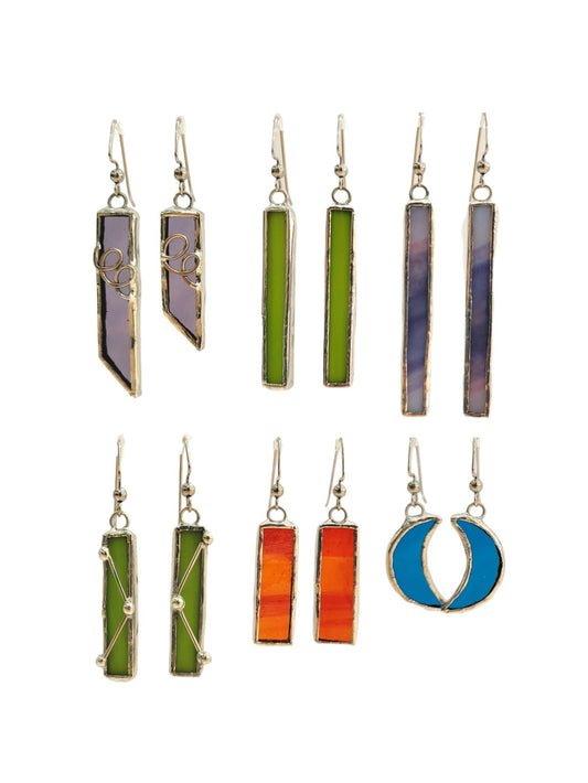 Set of colorful bar-shaped earrings on a white background